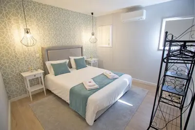 a small bedroom with a bed with two towels on it at Porto Views & Wines by Porto City Hosts in Vila Nova de Gaia