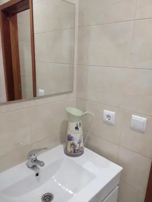a bathroom with a vase sitting on a sink at ML Apartments Central Aliados in Porto