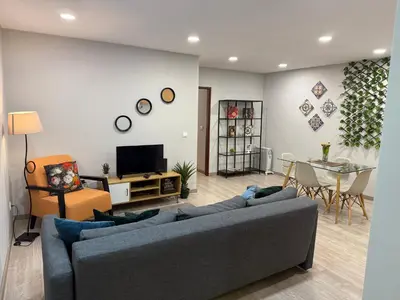 a living room with a blue couch and a table at ML Apartments Central Aliados in Porto