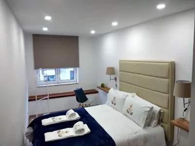 a hotel room with a bed with towels on it at ML Apartments Central Aliados in Porto