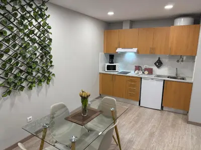 a kitchen with a table and chairs and a sink at ML Apartments Central Aliados in Porto