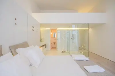 a white room with a glass shower and a bed at OHH - Mouzinho Deluxe Apartment in Porto