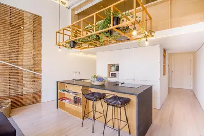 a kitchen with a counter and two stools at OHH - Mouzinho Deluxe Apartment in Porto