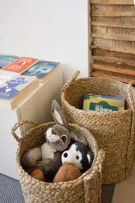 two baskets filled with stuffed animals next to a table at OHH - Mouzinho Deluxe Apartment in Porto