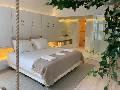 a bedroom with a bed with two towels on it at OHH - Mouzinho Deluxe Apartment in Porto