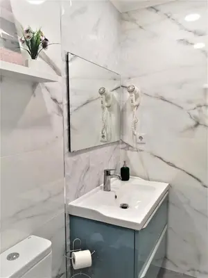 a white bathroom with a sink and a mirror at Porto Ville Touring in Porto