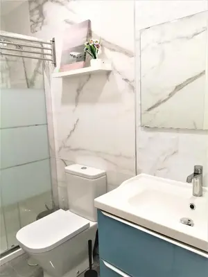 a bathroom with a white toilet and a sink at Porto Ville Touring in Porto