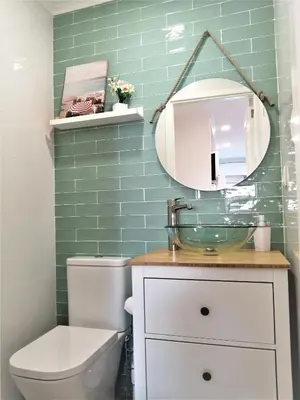 a bathroom with a toilet and a sink and a mirror at Porto Ville Touring in Porto
