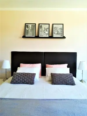 a bedroom with a bed with four pictures on the wall at Porto Ville Touring in Porto