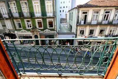 a view of a city street from a balcony at Invictus Place in Porto