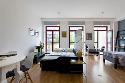 a living room with a bed and a dining room at Porto Terrace Apartment in Porto