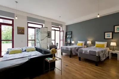a bedroom with two beds and a couch at Porto Terrace Apartment in Porto