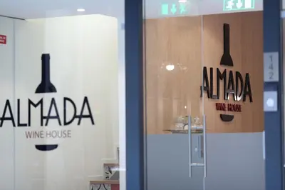 a glass door with a wine house sign on it at Almada Wine House - Tourism Apartments in Porto