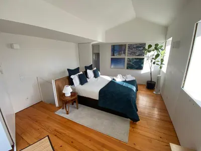 a bedroom with a bed with blue pillows at Casa Dona Olga River View in Porto