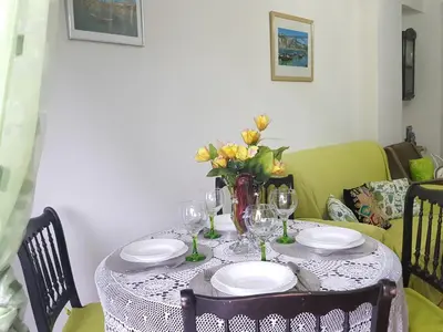 a vase of flowers sitting on a table with plates at Apartment Rustic Oporto in Porto