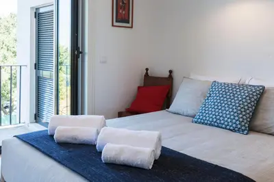 a bedroom with a bed with two pillows on it at Sunny Home in Porto