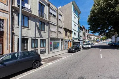 a street with cars parked on the side of the road at Sunny Home in Porto