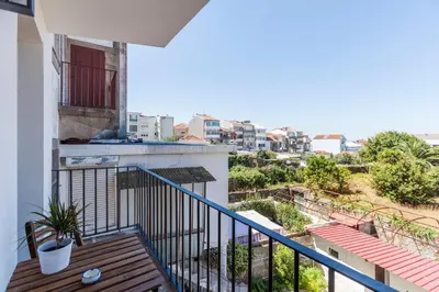 a balcony with a view of a city at Sunny Home in Porto