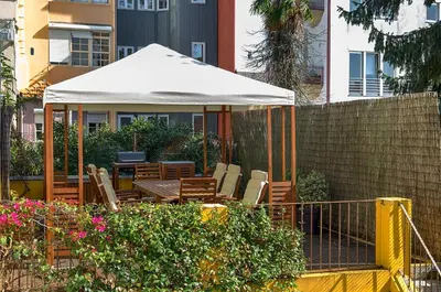 a gazebo with chairs and a table in a garden at Casa da Oliveira in Porto