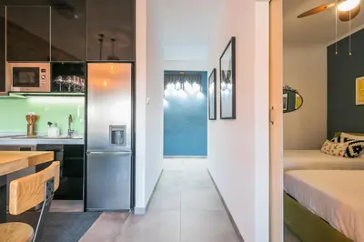 a kitchen with a refrigerator next to a bedroom at Merc Porto Ribeira's Up place in Porto