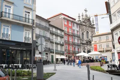 a city street with buildings and people walking around at Merc Porto Ribeira's Up place in Porto