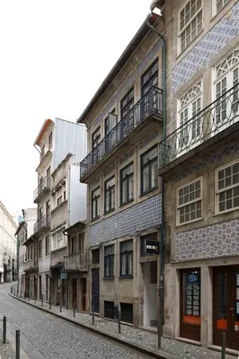 an empty street with a row of buildings at OportoHouse in Porto