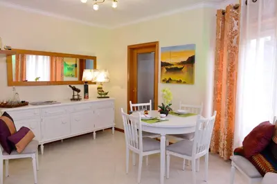 a dining room with a white table and chairs at Apartamento Porto Centro in Porto