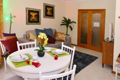 a living room with a table and a couch at Apartamento Porto Centro in Porto