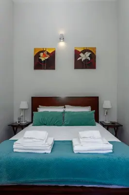 a bed with two towels on top of it at Bonjardim Terrace in Porto