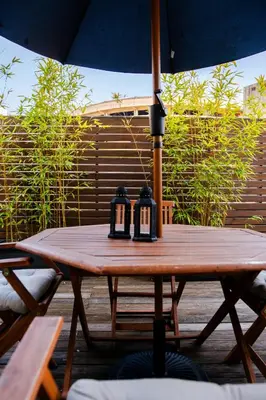 a wooden table with two candles on top of it at Bonjardim Terrace in Porto