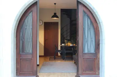 an entryway with two wooden doors and a table at AC House in Porto