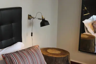 a bedroom with a table and a lamp and a bed at AC House in Porto