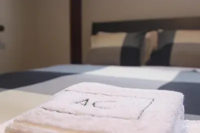 a towel sitting on top of a bed at AC House in Porto
