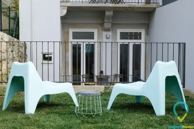 two chairs and a table in front of a house at Lovely Porto in Porto