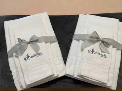 two white napkins with bows on top of a table at My Portugal for All - Oporto Flat in Vila Nova de Gaia