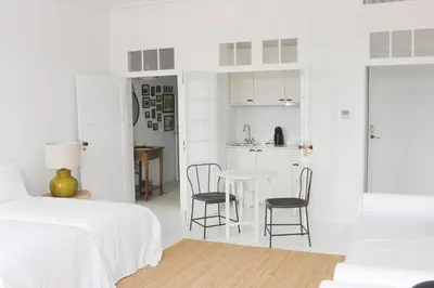 a white room with a bed and a table and chairs at Mo House in Porto