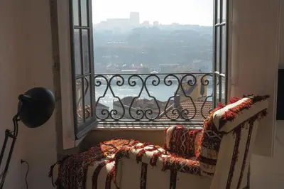a room with a balcony with a view of the water at Mo House in Porto