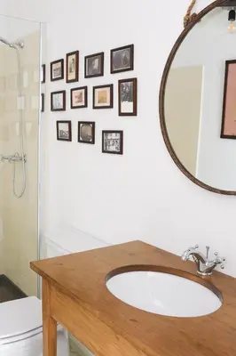 a bathroom with a sink and a mirror and a toilet at Mo House in Porto