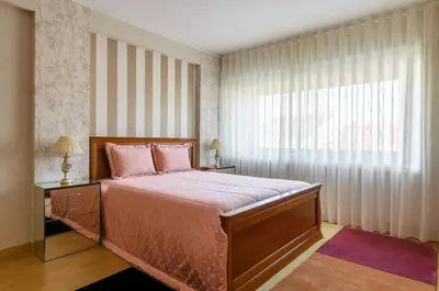 a bedroom with a large bed and a window at Porto Downtown Apartment in Porto