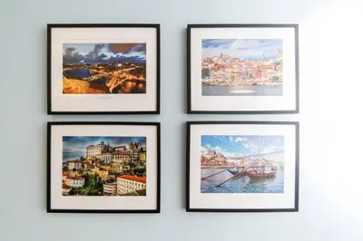 a group of framed photos on a wall at Porto Downtown Apartment in Porto