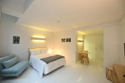 a bedroom with a bed and a blue chair at I Loft Porto in Porto