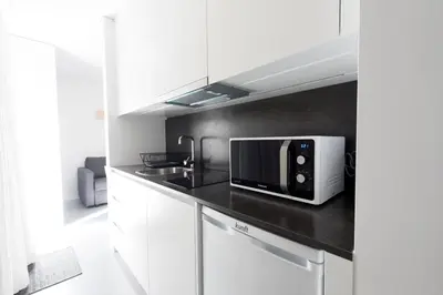 a kitchen with a microwave on a counter at I Loft Porto in Porto