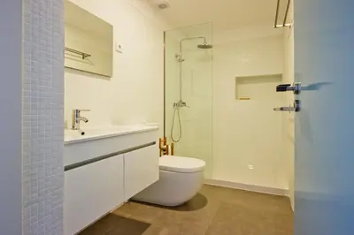 a bathroom with a toilet and a sink and a shower at Oliveirinhas Porto Apartment in Porto