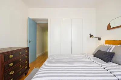 a bedroom with a large bed and a dresser at Oliveirinhas Porto Apartment in Porto