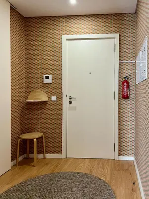 a room with a white door and a stool at Light-Filled Apartment with Garden • Downtown in Porto