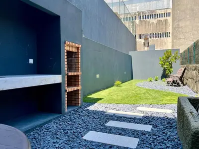 a garden with a stone walkway next to a building at Light-Filled Apartment with Garden • Downtown in Porto