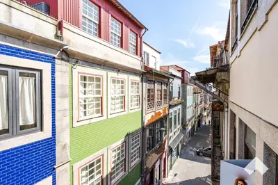 an alley in an old city with colorful buildings at Bright Apartment • Downtown Porto in Porto