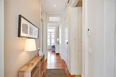 a hallway with a table and a lamp in a room at Inn Oporto Old Town Apartments in Porto