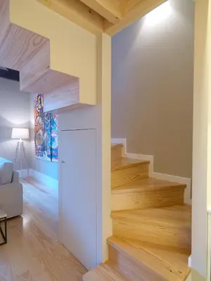 a staircase in a living room with wooden floors at Oporto Medusa Apartment in Porto