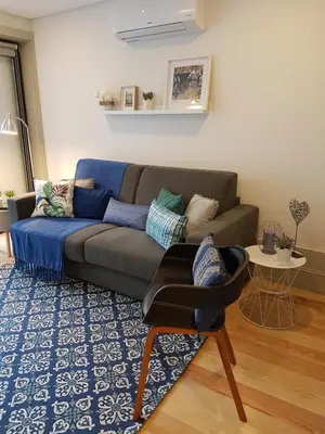 a living room with a couch and a chair at Porto Belo Clérigos in Porto